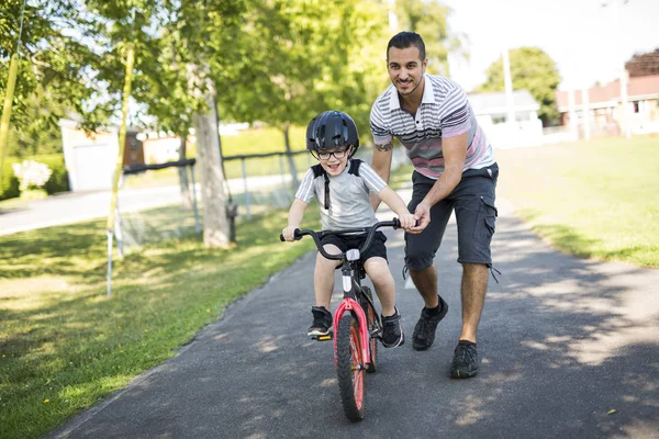 Père enseignement fils à monter à vélo — Photo
