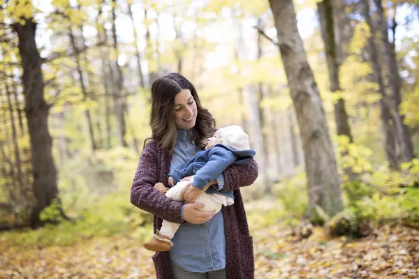 Mother with daughter baby in autumn forest — Stock Photo, Image