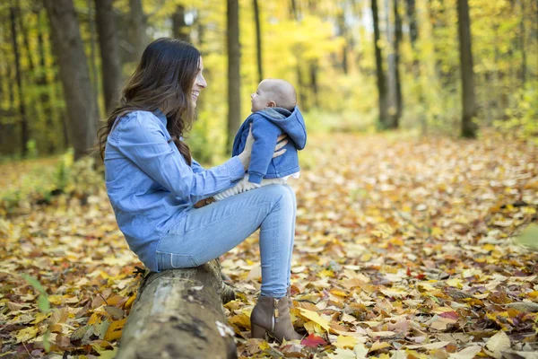 Mother with daughter baby in autumn forest — Stock Photo, Image