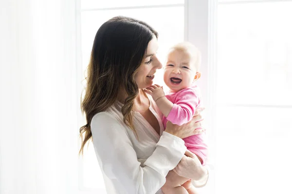 Newborn baby in the hand of his mother at the window — Stock Photo, Image