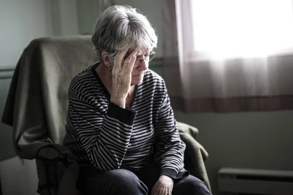 Worried senior woman at home felling very bad — Stock Photo, Image