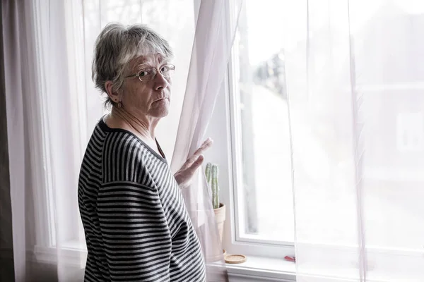 Worried senior woman at home felling very bad — Stock Photo, Image