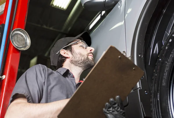 Mécanicien travaillant sur la voiture dans son atelier — Photo