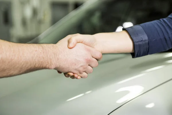 auto mechanic and female customer in garage