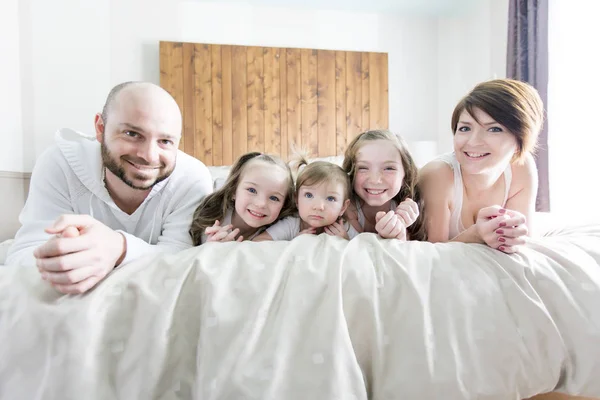 Молодая счастливая семья из пяти человек на спальне — стоковое фото