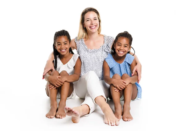 Afro twin child posing on a white background studio with white mother — Stock Photo, Image