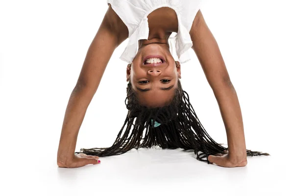 Little girl upside down on a white background — Stock Photo, Image