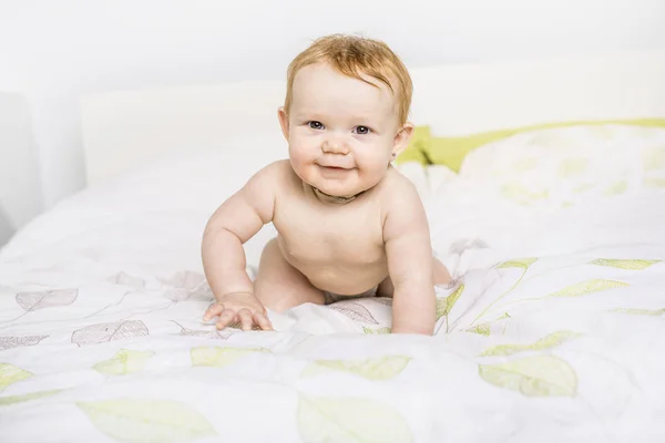 Portrait of a crawling baby on the bed in her room — Stock Photo, Image