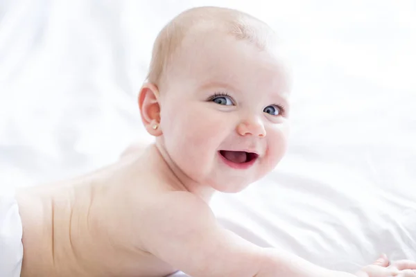 Baby girl in white bedding at home look nice — Stock Photo, Image