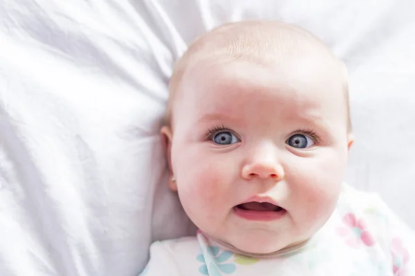 Baby girl in white bedding at home look nice — Stock Photo, Image