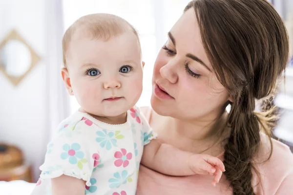 Mother and baby hugging at bedroom — Stock Photo, Image