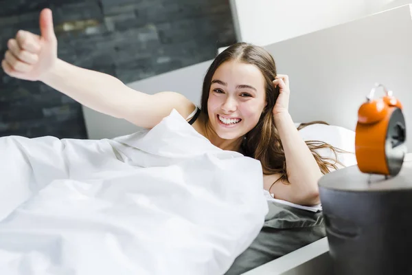 Beautiful young woman with long hair sleeping on bed in bedroom — Stock Photo, Image