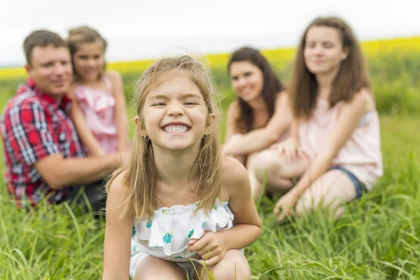 Family outdoors on a yellow field — Stock Photo, Image