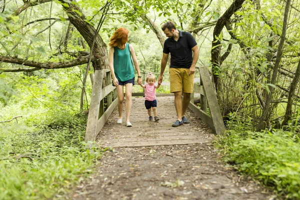 Mother, father and daughter on the promenade. First steps — Stock Photo, Image