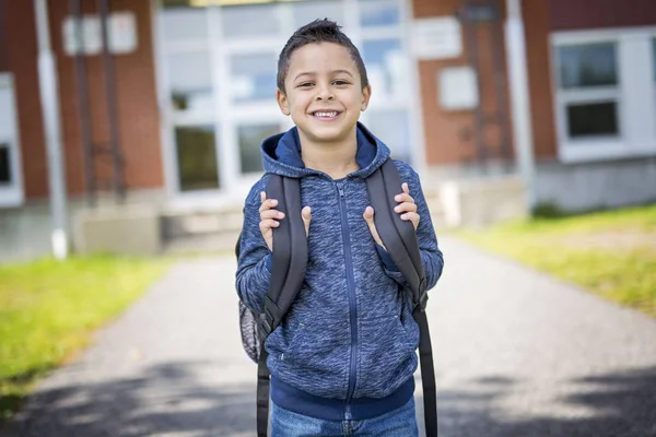 Student outside school standing smiling — Stock Photo, Image