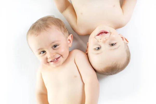 Twin brother having fun on a studio white floor — Stock Photo, Image