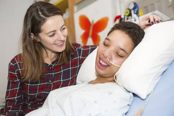 Больной пациент лежит на кровати в больнице на медицинском фоне — стоковое фото