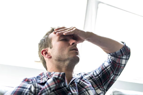 Young man suffering from headache at home — Stock Photo, Image