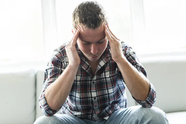 Junger Mann leidet zu Hause unter Kopfschmerzen — Stockfoto