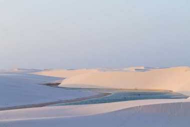 White sand dunes panorama from Lencois Maranhenses National Park, Brazil. Rainwater lagoon. Brazilian landscape clipart
