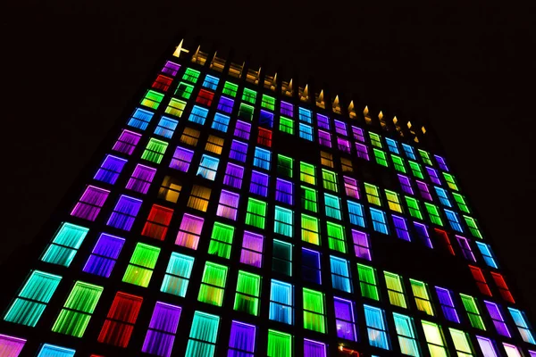 Colored windows texture.  Windows illuminated by neon lights background.