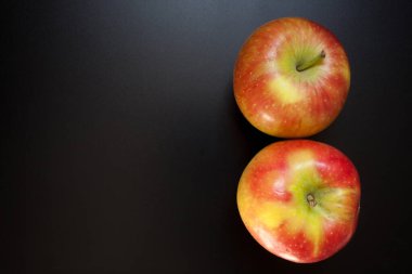 Elmalar siyah masada, yemek arkaplanda. İzole edilmiş elmalar
