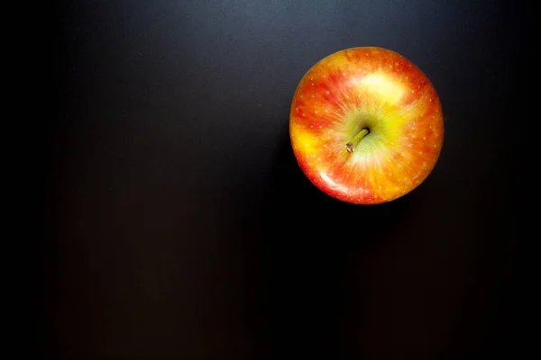 Apple on black table, food background. Isolated apple
