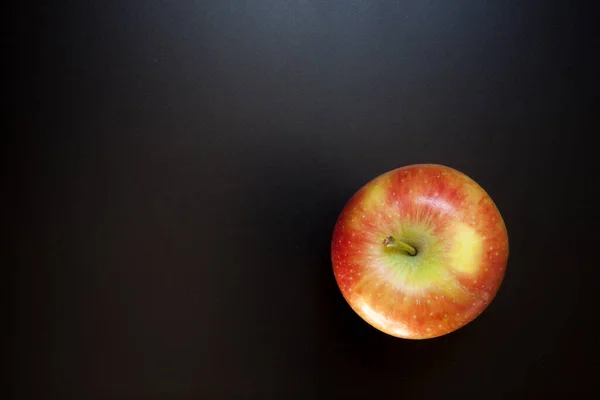 Apple on black table, food background. Isolated apple