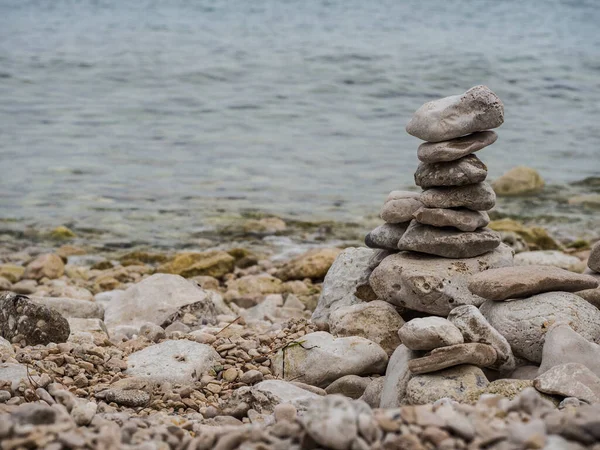 Zen stones on beach, pile of stones by the sea