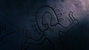 Işık huzmesindeki kayaya oyulmuş Uzay Adamı