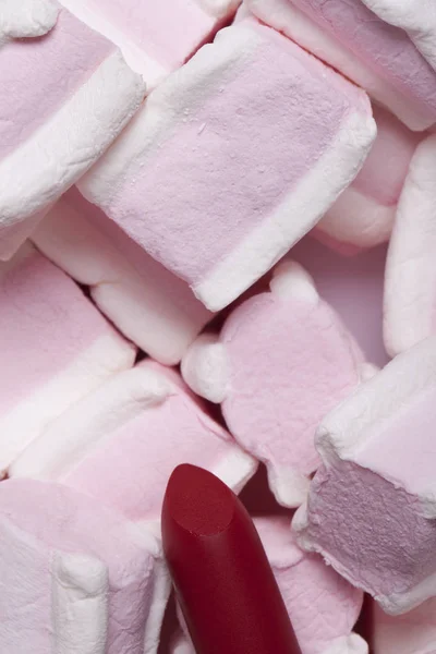 Red lipstick on a background of sweets — Stock Photo, Image