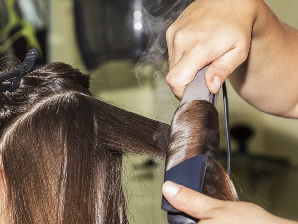 Κάνοντας curles με σίδερο μαλλιών στο κομμωτήριο — Φωτογραφία Αρχείου