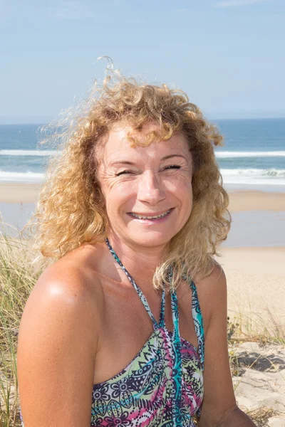 Яркая фотография смеющейся женщины на пляже . — стоковое фото