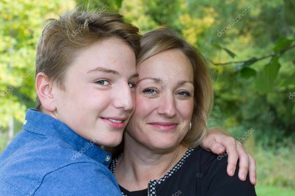 Lovely mother and son in the spring meadow outdoor portrait 