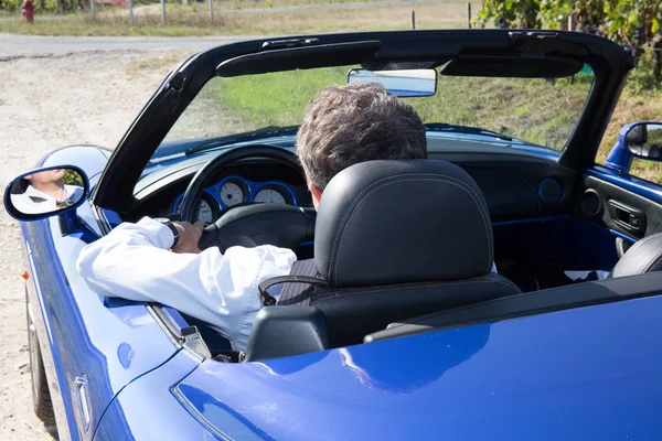 Man driving in open top car back view — Stock Photo, Image