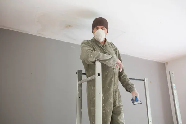 Man painting facade builder worker with roller