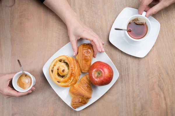 Wooden table with classical French breakfast with croissants, tea, coffee — Stock Photo, Image