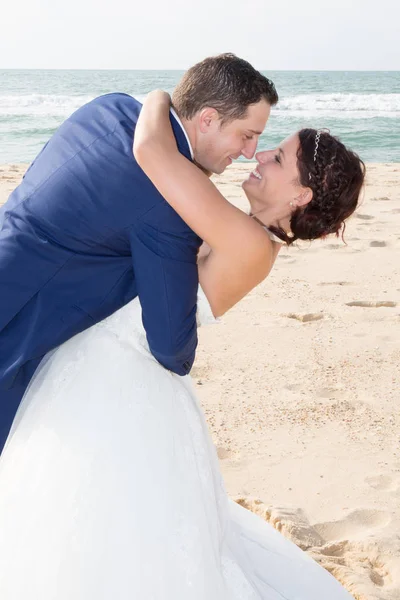 Novomanželé sdílení romantické chvíle na pláži — Stock fotografie