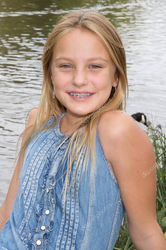 Blond Preteen Girl In Blue Dress Close Up Summer Photo On