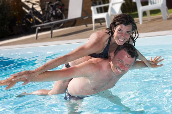 Lovely couple in love in the swimming pool enjoy vacation summer — Stock Photo, Image