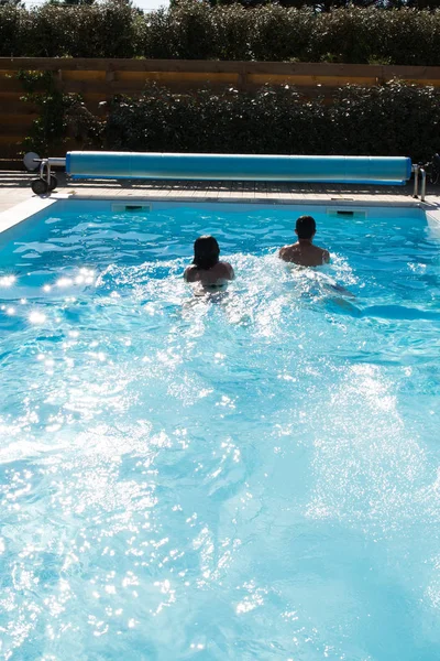 Una gara tra madre e figlio in piscina — Foto Stock