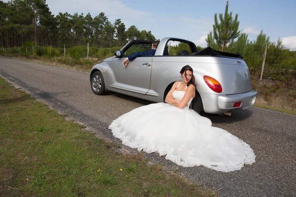Λυπημένη γυναίκα κατά την ημέρα του γάμου μπροστά αυτοκινήτου γάμου — Φωτογραφία Αρχείου