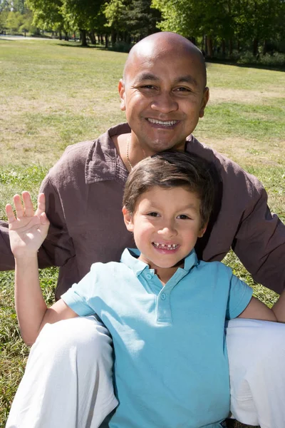 family of spanish origin with father and son enjoys the park