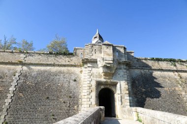 The entrance of a medieval castle in France in Europe clipart