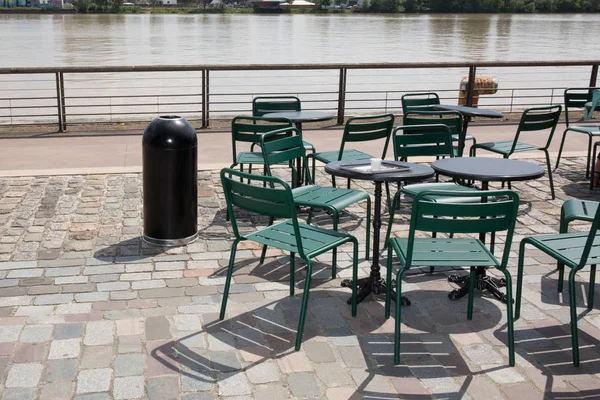 Restaurant chairs on the banks of the quays in Bordeaux in france — Stock Photo, Image
