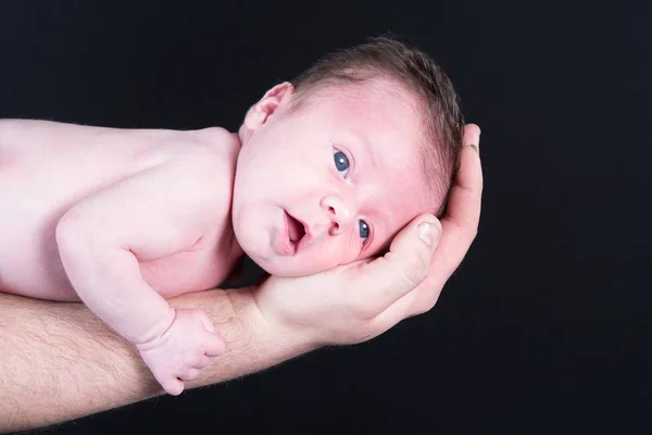 Newborn baby in the arms of his father — Stock Photo, Image