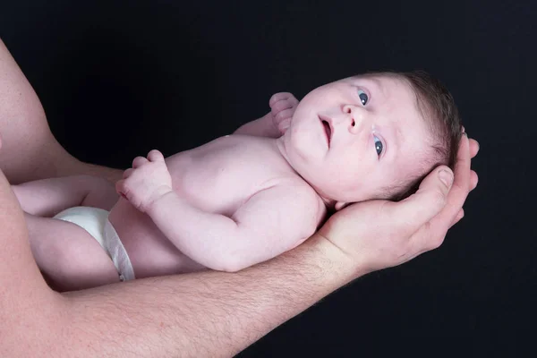 Newborn baby lying on the arm of his father — Stock Photo, Image