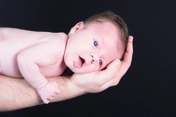 Smiling new born baby in father arms — Stock Photo, Image