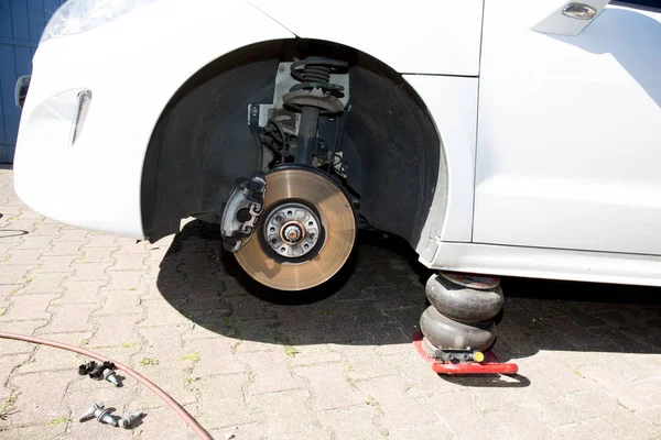 Car on jack without the front wheel — Stock Photo, Image