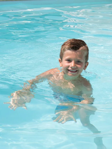 Happy kid boy swimming in pool resort — Stock Photo, Image